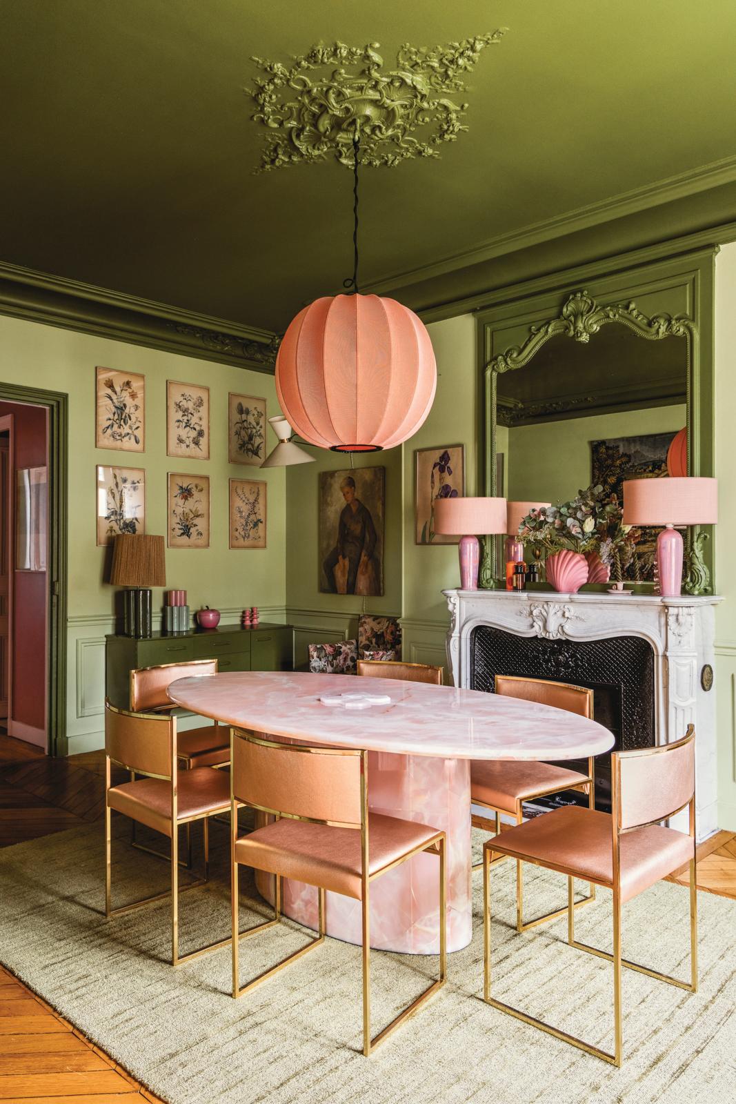 Two shades of green create a moody effect in the dining room