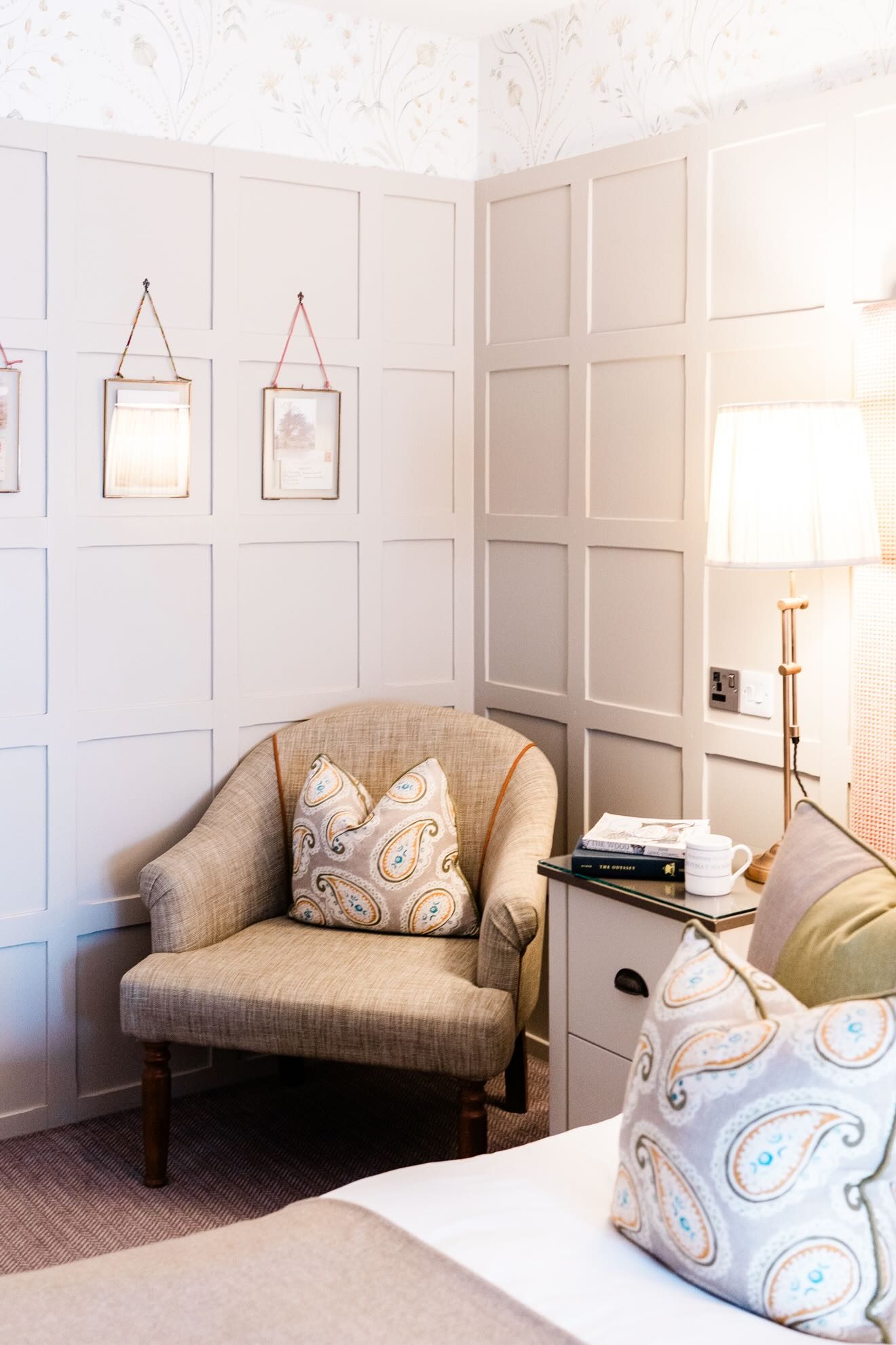 Corner of room designed in pale colours, with beige armchair