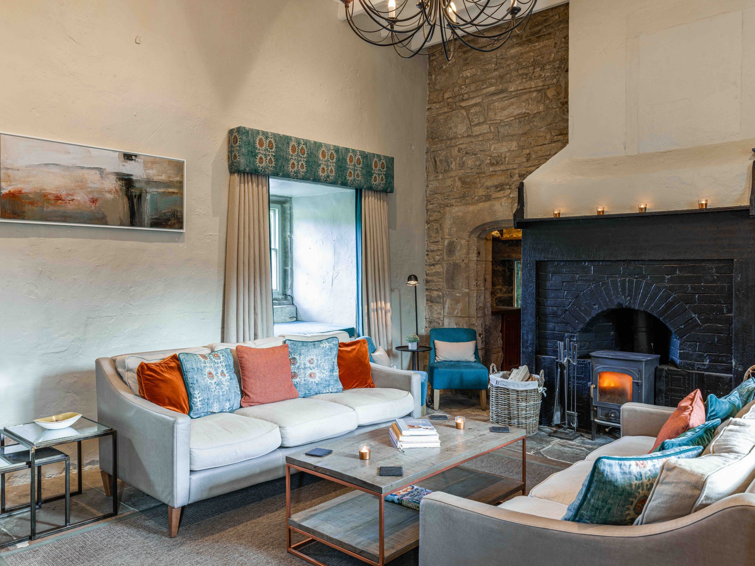 Country hotel interior with sofas and log burner